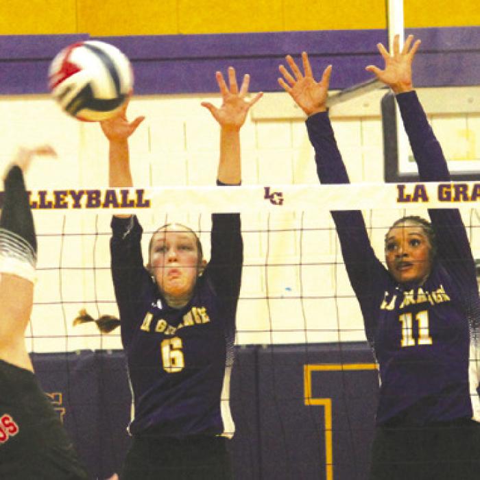 La Grange’s Gabby Hollek, center and Brion Williams, right, jump to block this hit by a Brazos player in Tuesday’s match. Photo by Jeff Wick