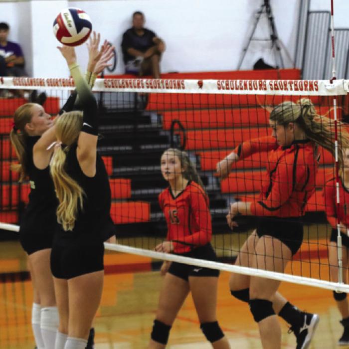 Schulenburg’s Haylee Vacek, right, spikes a ball in Tuesday’s match as a pair of Round Top-Carmine players try to block. Photo by Audrey Kristynik