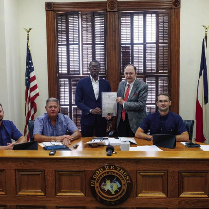 Dexter Jones of Mount Olive Baptist Church in Armstrong Colony was on hand for the proclamation signing last Thursday. Pictured (from left) are Pct. 4 Commissioner Drew Brossmann, Pct. 3 Commissioner Harvey Berckenhoff, Dexter Jones, County Judge Dan Mueller, and Pct. 2 Commissioner Clint Sternadel. Photo by Andy Behlen