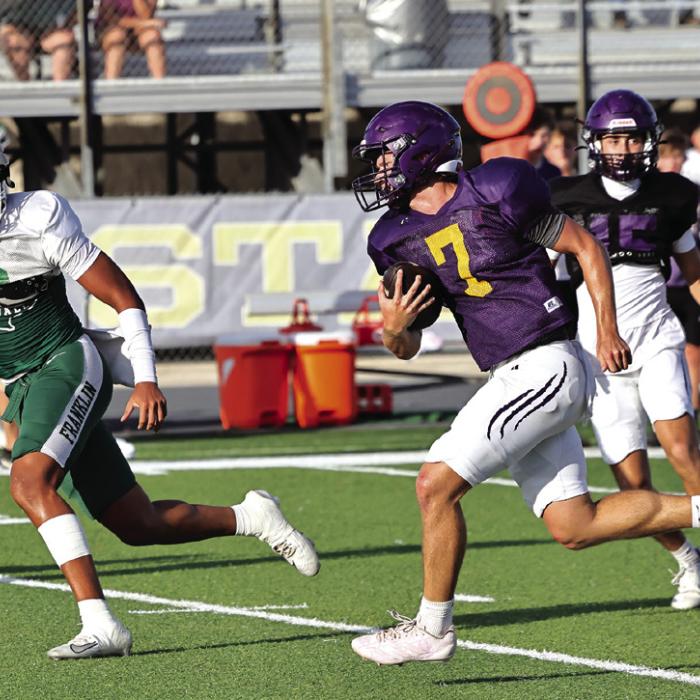 Eli Gillum finds some running room in Thursday’s scrimmage against Franklin. He ran for a touchdown and threw for two more TDs. Photo by Darrell D. Gest
