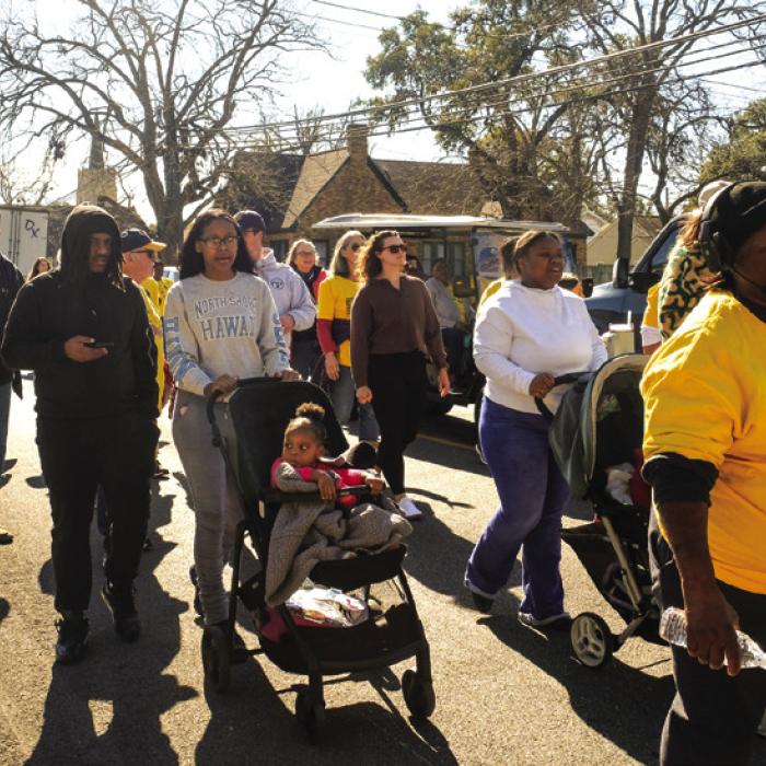 The group walking in the MLK Jr. Day March makes their way down Jefferson St. from Fayette Public Library on their way to the Courthouse. Photo by Andy Behlen