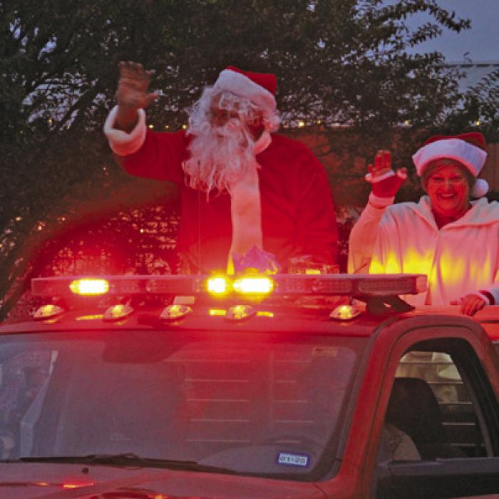 Santa and Mrs. Claus rode into town in the evening twilight atop a La Grange firetruck.