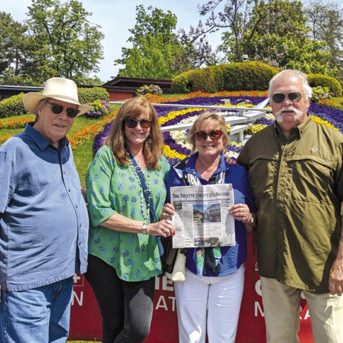 Charlie and Seri Davis and Frank and Linda Jones of La Grange took The Fayette County Record along when they were in Geneva, Switzerland. They are pictured standing in front of the world famous Flower Clock, created in 1955, the flowers change depending on the season.