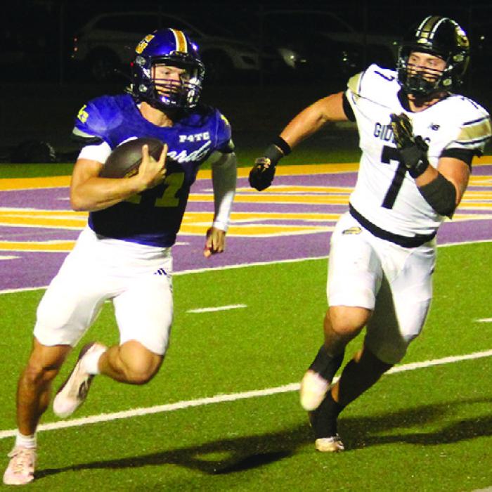 La Grange quarterback Eli Gillum gets around Giddings’ Corbin Medack and would keep going en route to a 94-yard touchdown Friday. Photo by Jeff Wick