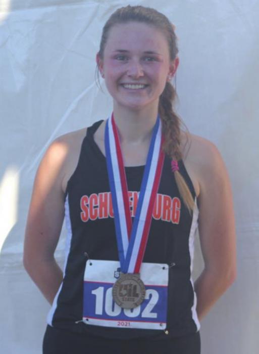 Schulenburg’s Taylor Limbaugh wearing her silver medal after the 3200 meters Friday. Photo by Brian Pierson