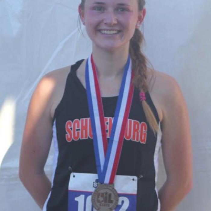 Schulenburg’s Taylor Limbaugh wearing her silver medal after the 3200 meters Friday. Photo by Brian Pierson
