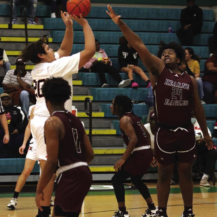 Schulenburg’s Ignacio Hernandez shoots over a Hearne player.
