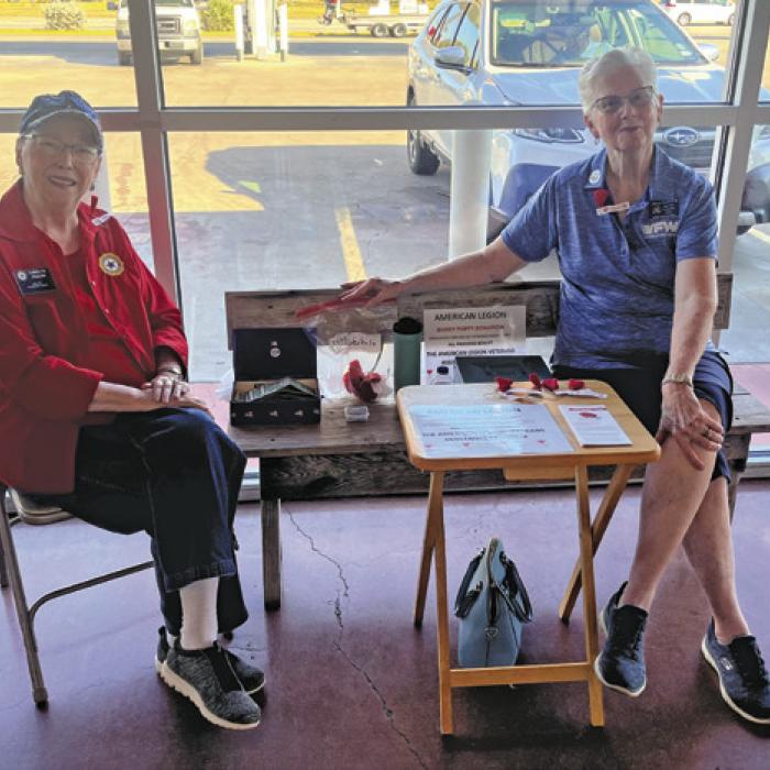 Carolyn Prause, left, and Twila Thurman, right, of the American Legion and VFW Auxiliaries were selling Buddy Poppies Friday at Weikel’s in La Grange in honor of Veterans Day weekend. The poppy is the official memorial flower of the Veterans of Foreign Wars of the United States and funds from the sales go to help veterans aid organizations. Photo by Jeff Wick