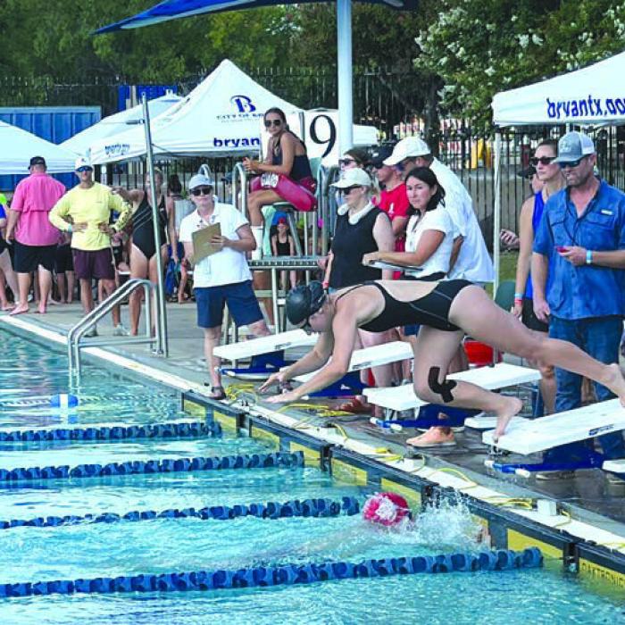 Makenna Emmel diving in on a relay.