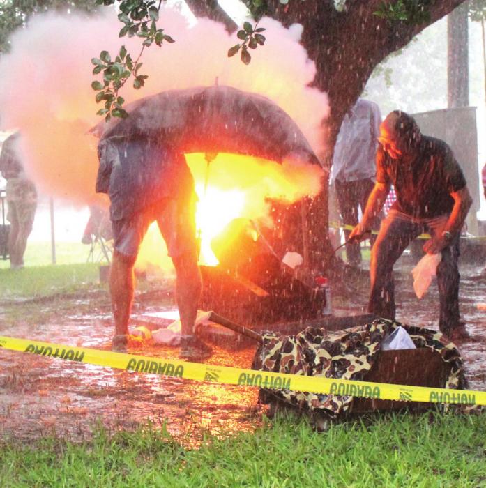 The Round Top Fourth of July parade went on as scheduled Sunday amidst a downpour that lasted all morning. They were even able to fire off the cannon that signaled the start of the parade, with the help of an umbrella. Photo by Jeff Wick