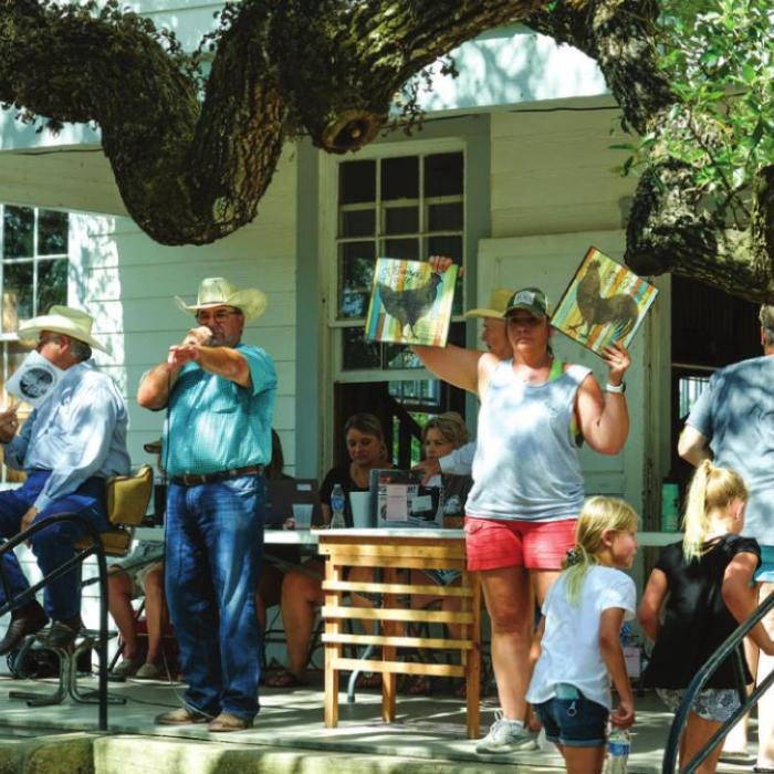 Auctioneer Joe Orsak calls out the bids at the Dubina picnic auction.
