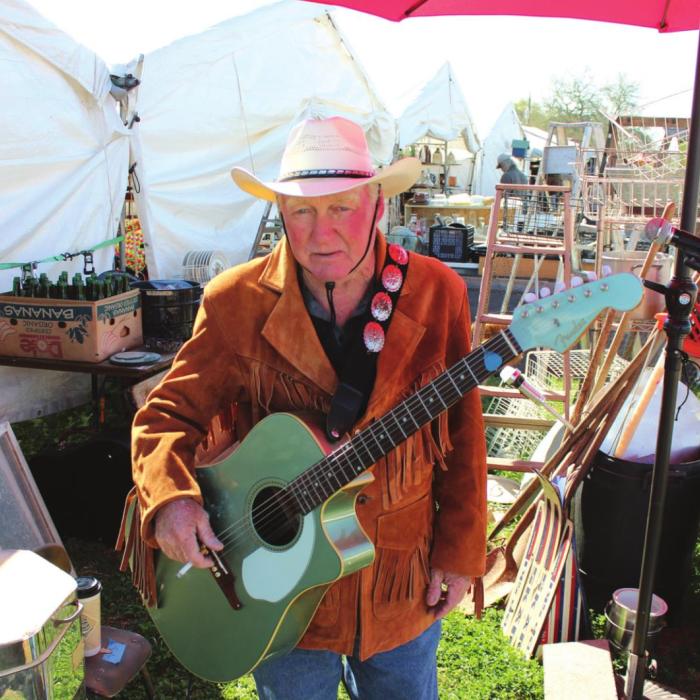 Fayetteville’s Randall Beck has been playing guitar and singing for tips at the same spot amidst the Warrenton antiques for three years. Photos by Jeff Wick
