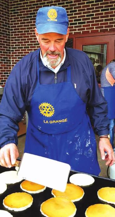 Dr. Randy Albers flipping pancakes at the annual Rotary fundraiser.