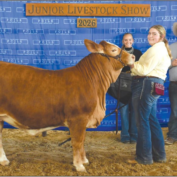Grand Champion Heifer - Rheagan Karisch, Pure Country 4-H; Grand Champion Buckle Sponsor - KPK Manufacturing. Reisy Janea pictured holding bag and Rilan Karisch holding buckle and banner.