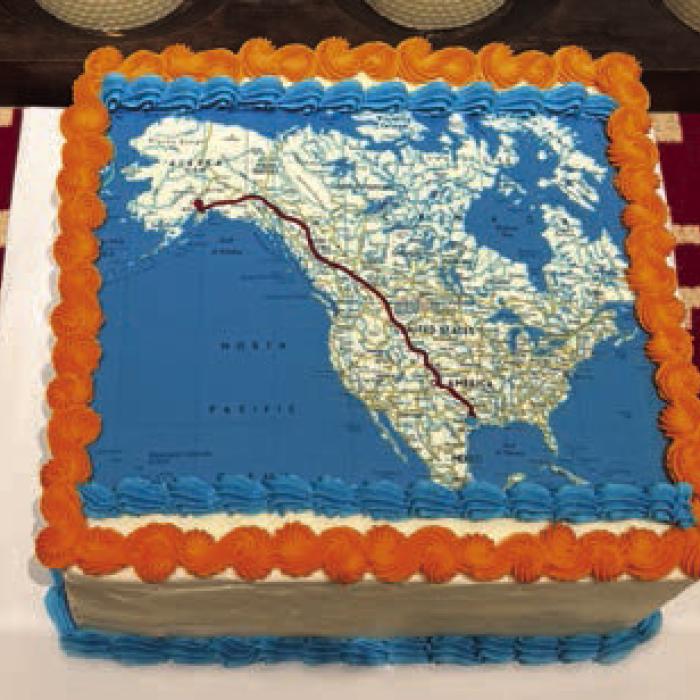 Cake artist Joan Hoffmann donated one of her custom cakes for the evening decorated with the team’s route from Austin to Alaska. As Lead Rider for the day, Laura Toledo wears the flag hoodie that has been passed down from previous Texas 4000 rides.