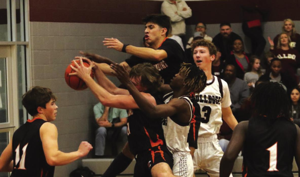Players from both teams battle for a rebound Friday in Flatonia. Photo by Audrey Kristynik