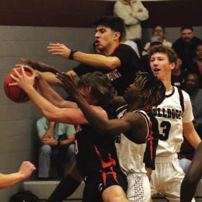 Players from both teams battle for a rebound Friday in Flatonia. Photo by Audrey Kristynik