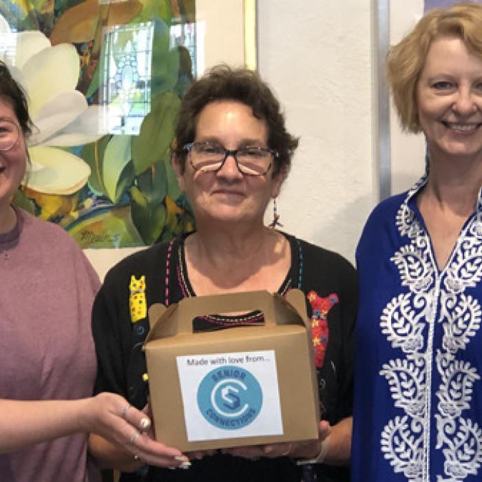 Tory Farley, Stephanie Shroyer, and Sandra Bourne with backed goods from the center delivered to Arts For Rural Texas.