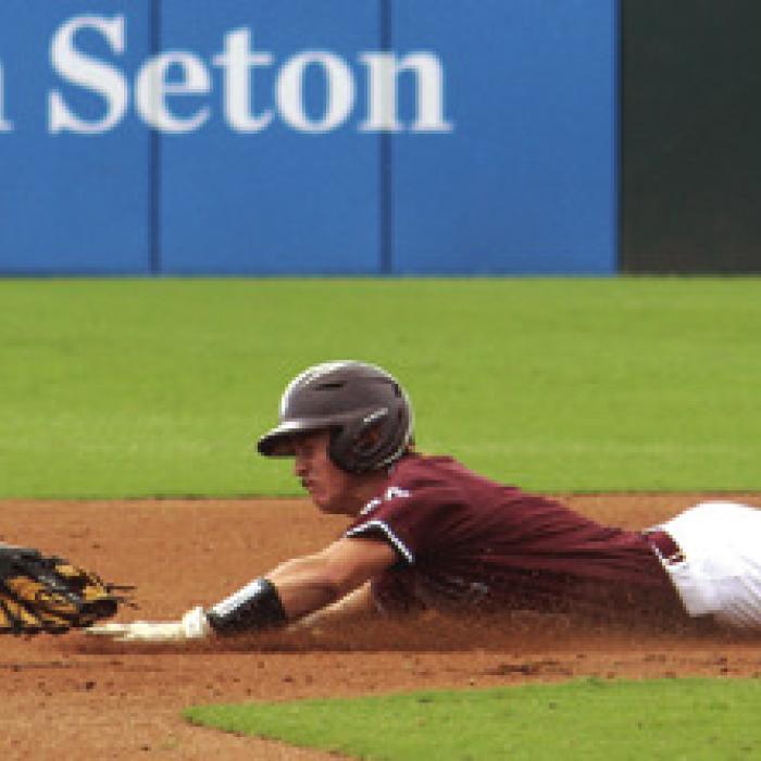 Lawson Fritsch steals a base in the title game. Photo by Jeff Wick