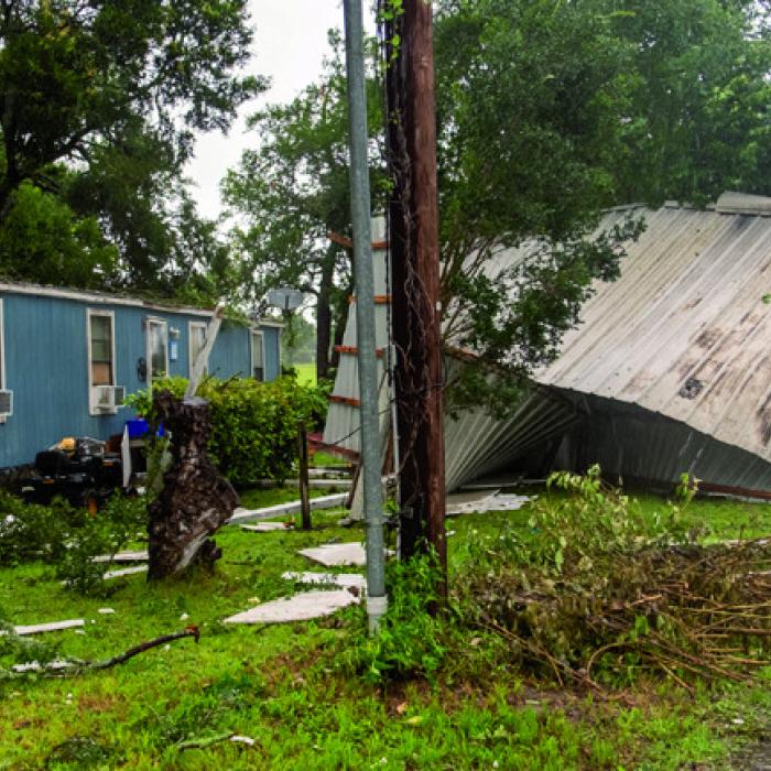 Thursday’s storm ripped a roof off a manufactured home on Eblin St. in La Grange (left), and it tore apart a large cattle barn off Mode Ln. (above). Photos by Andy Behlen