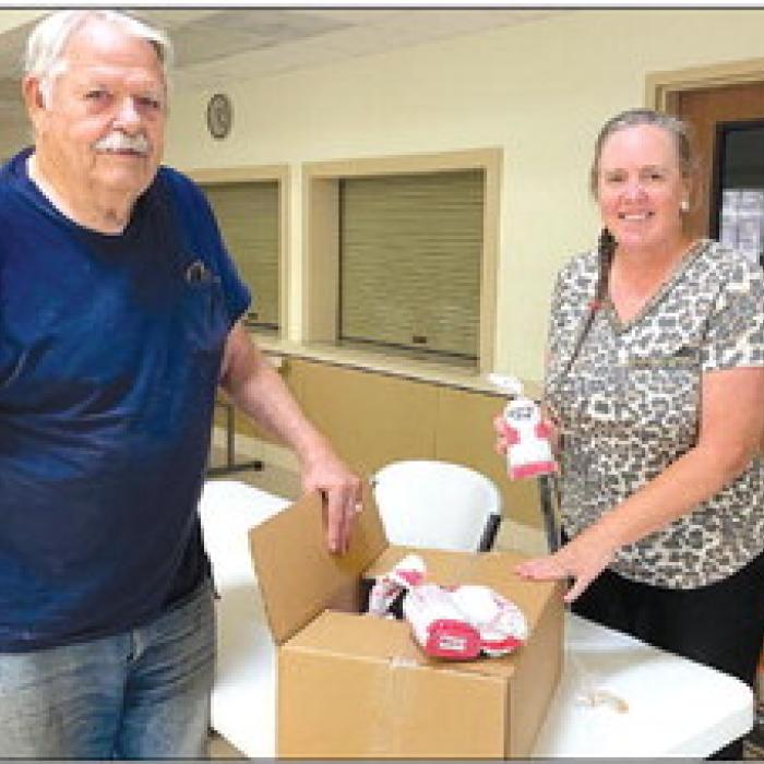 The Columbus Food Bank received a donation from CattleWomen. Pictured is Susie Shank, NVCW, and Tom Fleming, Columbus Food Bank.