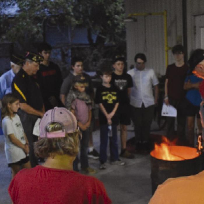 American Legion Post #338 with assistance for Carmine 4H students dispose of an American Flag as part of the Flag Disposal Ceremony held in association with the Carmine Chamber of Commerce Night Out on Oct. 1.