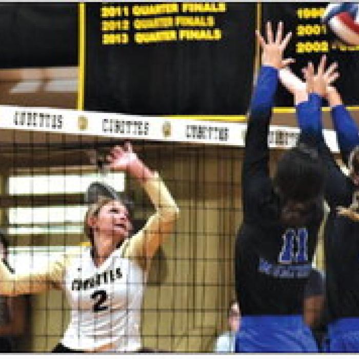 RT-C’s Tess Eilers hits a ball over a Mumford block in Tuesday’s victory. Photo by Paul Kipp
