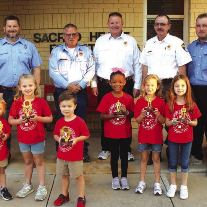 Pre-K and Kindergarten Division – Left to right, Winners: Adelyn Montgomery, Sami Montgomery, D.J. Wick; Honorable mention – Adelunn Brown, Heidi Gaertner, Rylee Mozisek. Back row: La Grange firefighters Chris Kaspar, Kenneth Chovanec, Todd Johnson, Glen Knigge, and Blythe Vitek. Photo by Jeff Wick