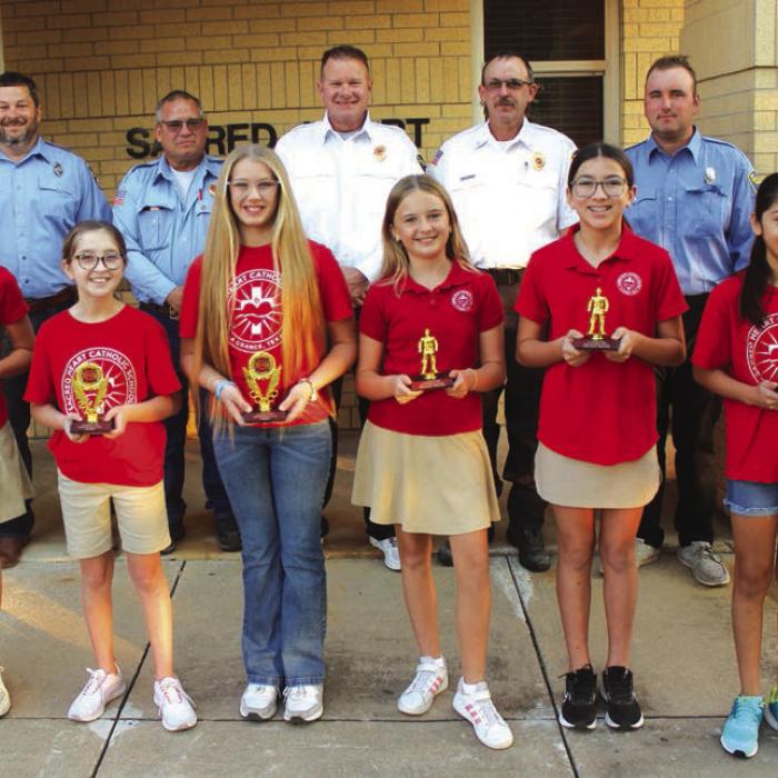 5th and 6th Grades – Left to right: Adalyn Emmel, Kacie Nichols, Kirtley Kallus; Honorable mention: Helen Streiff, Taylyn Newton, Giah Garcia. La Grange firefighters Chris Kaspar, Kenneth Chovanec, Todd Johnson, Glen Knigge, and Blythe Vitek. Photo by Jeff Wick