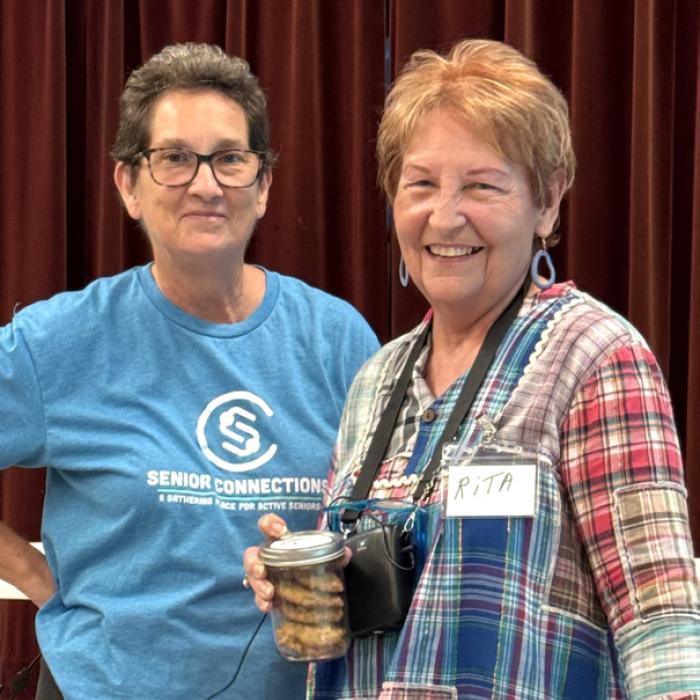 Stephanie Shroyer, Program Director with Senior Connections, is pictured here presenting Rita Hays with cookies from the cookie roundup for her bravery for sharing her story for Senior Spotlight in Weimar. Her story was very compelling about how painting and her love of horses brought her through some very difficult times.