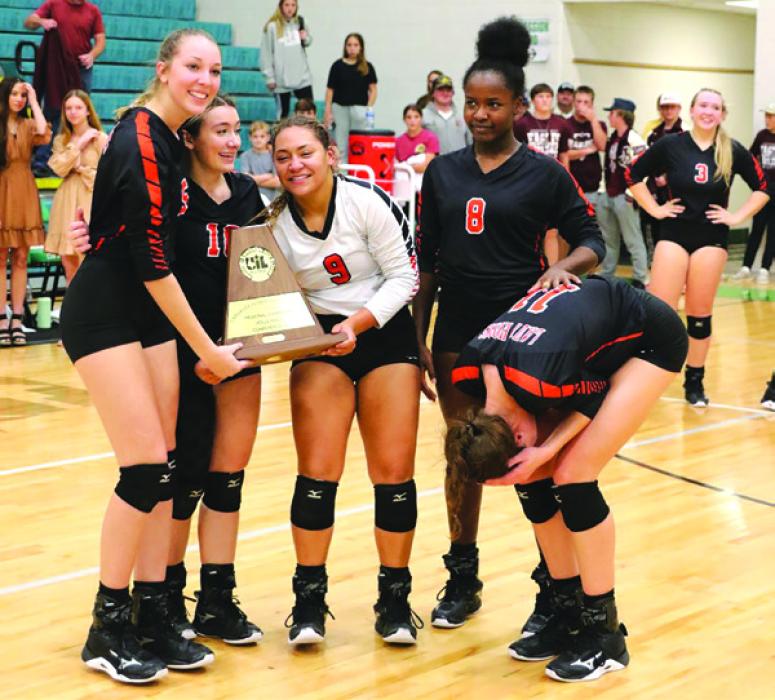 The five seniors on the Lady Horns team accept the regional title trophy Saturday, left to right: Brooke Redding, Keaton Walker, Kieryn Adams, Jessalyn Gipson and Meredith Magliolo, still emotional after she scored the final point.