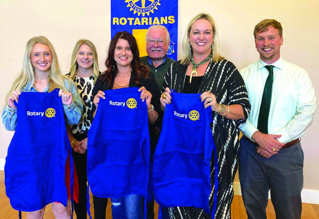 New Rotary Club members are (from left) Bailey Taylor, Dawn Sedlar and Jennifer Schattle. Behind them are sponsors Katie Swafford and John Wied, along with Kyle Hartmann, club president.