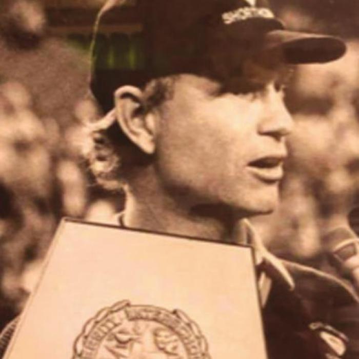 David Husmann is shown here holding the state title trophy and being interviewed after winning one of the two football titles he led the Shorthorns to.
