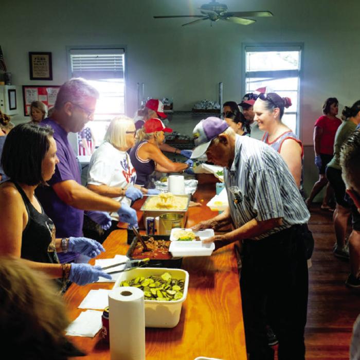 The serving line inside the St. John Parish Hall was already crowded by 10:30 a.m.
