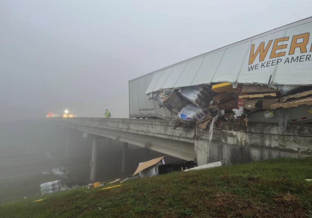 An 18-wheeler box trailer sideswiped the guardrail on SH 71 Bypass near Oviedo Dodge in La Grange Tuesday morning. The guardrail sliced open the trailer and cargo spilled out along the highway. Photo courtesy of the Fayette County Sheriff’s Office