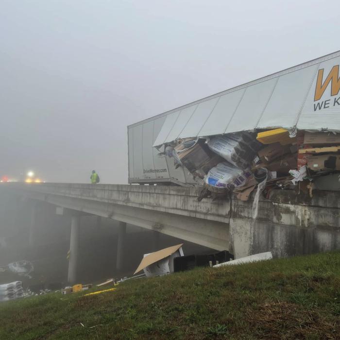 An 18-wheeler box trailer sideswiped the guardrail on SH 71 Bypass near Oviedo Dodge in La Grange Tuesday morning. The guardrail sliced open the trailer and cargo spilled out along the highway. Photo courtesy of the Fayette County Sheriff’s Office
