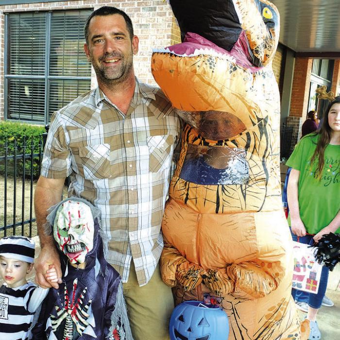 Joey Gilliam with kids Joseph Gilliam, Ezra Gilliam and Braiden Ledbetter were among the scores of trick-or-treaters on the Square Monday.