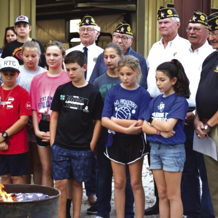 American Legion Post #338 with assistance for Carmine 4H students dispose of an American Flag as part of the Disposal Ceremony held in association with the Carmine Chamber of Commerce Night Out on October 6, 2022