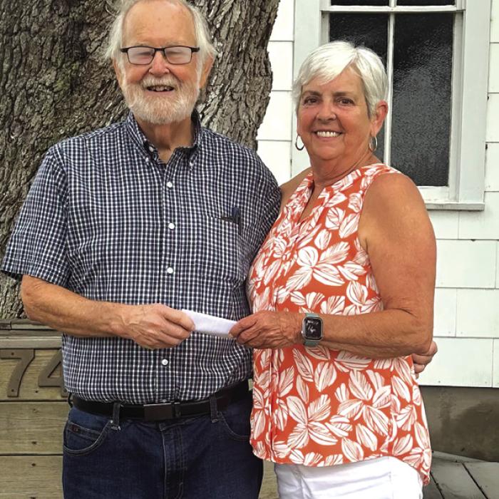 CASA Treasurer Phil Oestreich received a donation from St. John Council Rep. Sharon Fritsch