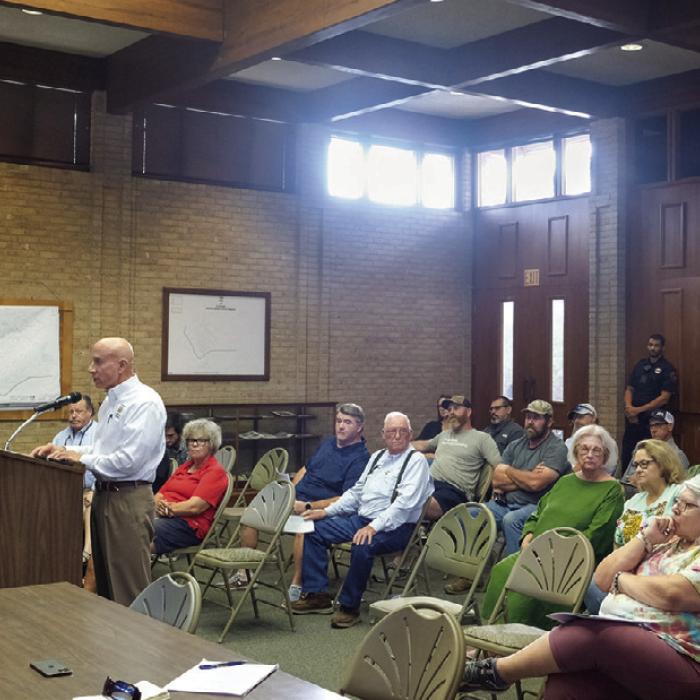 Local architect Brad Cutright, pictured speaking at the podium during Monday night’s La Grange City Council meeting, was among seven local business people and building contractors who pleaded with the City Council to hire an in-house building official. They complained of increased costs, delays and communication problems ever since the City outsourced the permitting and inspection process. Photo by Andy Behlen