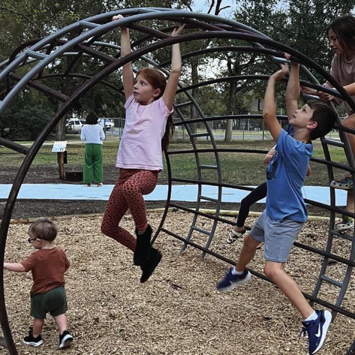 Families enjoy the “Barrel of Monkey Bars” sculpted by designer Chris Levack.