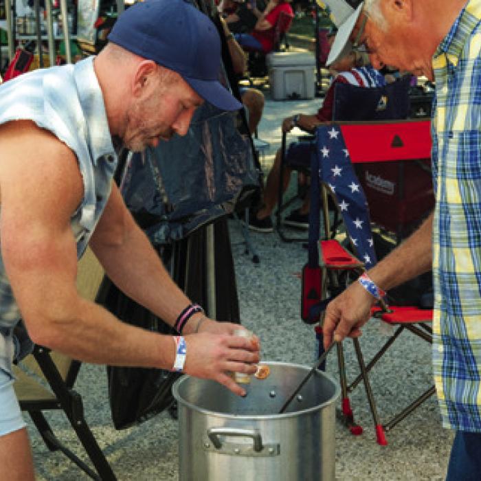 Jason Svatek of Houston (left) and his dad Jerome Svatek of Flatonia (right) add a pinch of garlic powder to their pot of chili. Their team is called “High Voltage Chili,” and they’ve cooked at just about every Czhilispiel since 2005.
