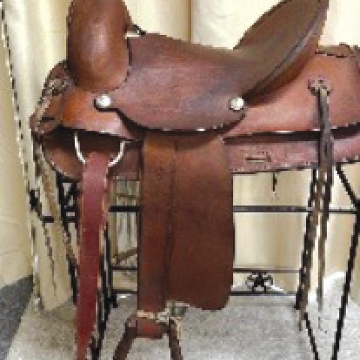 Items up for bids include a this 2-year-old bred F1 Heifer, saddle, queen size quilt, and handmade cedar adirondack chair. Other items include a blue rosary, homemade pastries, deer feeder, and home canned products.