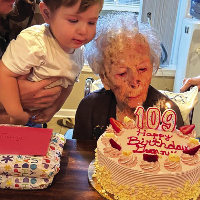 Mary Lee Mewis’ great, great grandson Hudson helps her blow out her candles on her birthday cake last Wednesday at her 109th birthday party in La Grange. Photo courtesy of Stacie Karstedt