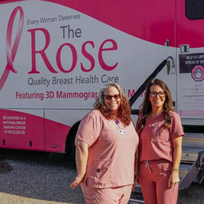 Tejas Health Care Director of Nursing Kellie Jakobeit (left) and patient coordinator Brandy Wessels (right) stand outside The Rose mobile mammography bus, which visited La Grange on Tuesday to offer breast cancer screenings to uninsured patients. Tejas Health Care will team up with The Rose to offer another screening event at their Giddings clinic on Dec. 9. Photo by Andy Behlen