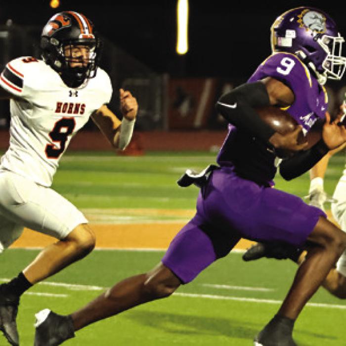Aiden Bayer and Reid Janda pursue the Marlin QB. Photo by Darrell D. Gest