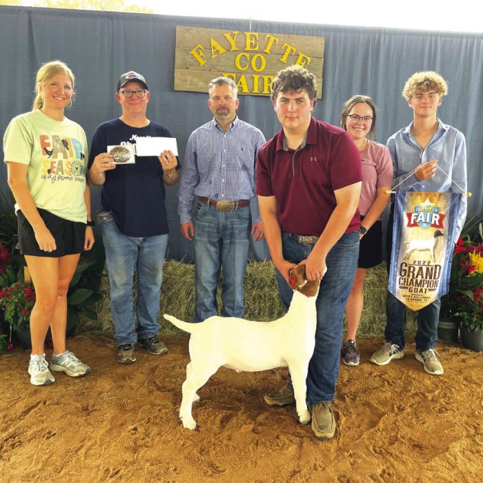 GOAT SHOW • OVERALL GRAND CHAMPION Neil Johnston with, back row, from left, buckle sponsor Megan Mozisek, Rocky Hill Farms; Patrick Johnston, Judge Troy Oliver, Faith Academy Ag Teacher Cierra Hines and John Poorman.