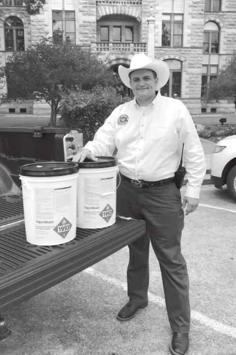 Fayette County Chief of Emergency Management and Homeland Security Craig Moreau with the 15 gallons of hand sanitizer donated by ExxonMobil.