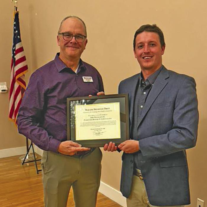 Master of Ceremonies Mac Brooks, right, presenting the Business Achievement Award to John Bartos, representing the Texas Czech Heritage and Cultural Center.