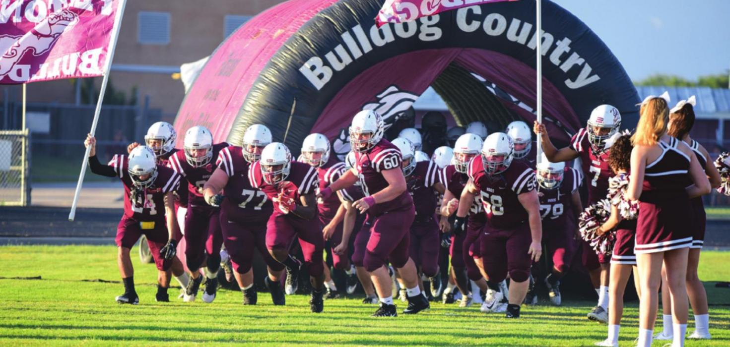 The Flatonia football team won’t be running out onto a grass field for games anymore, like they did here before a game in 2018. Instead, they’ll be playing on artificial turf. File photo by Stephanie Steinhauser